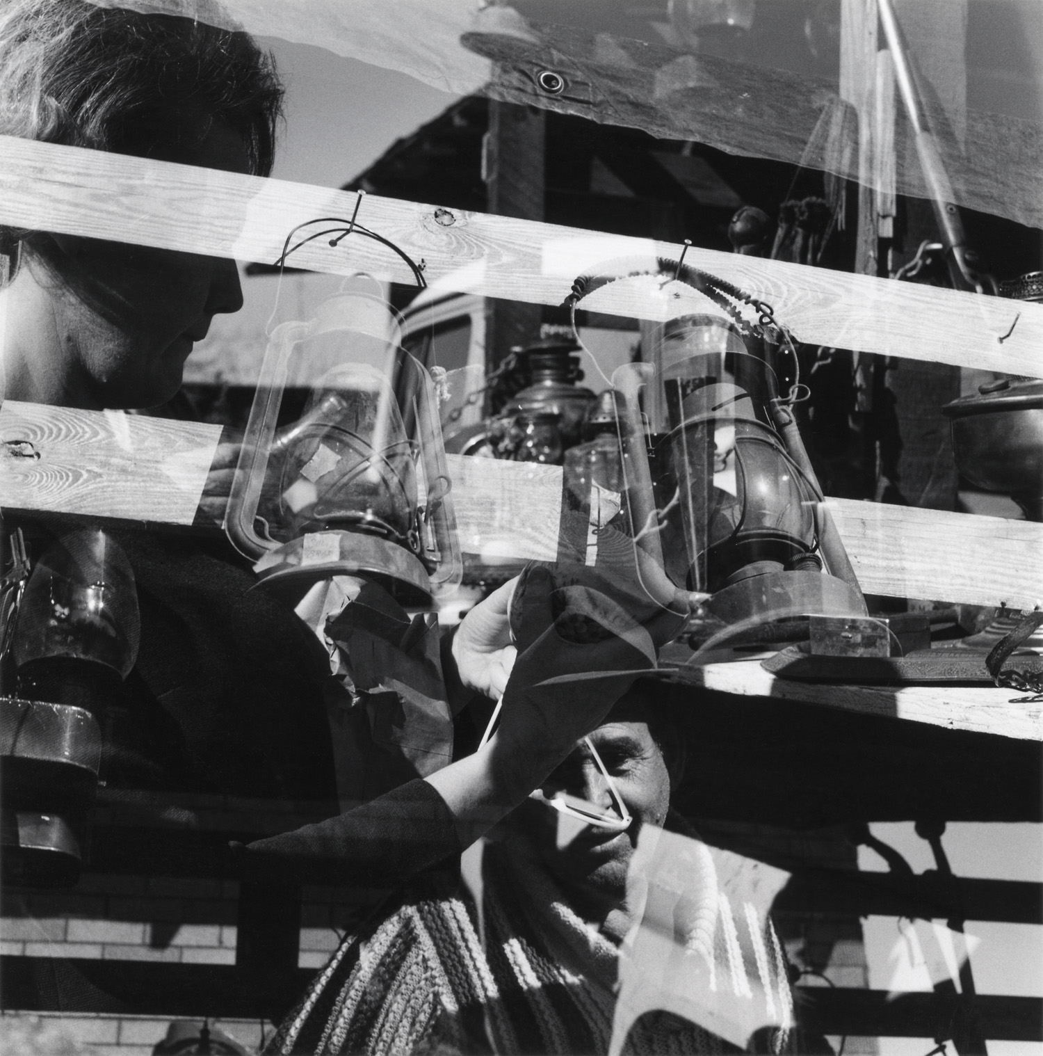 Robert C. May, Untitled [Fence, lanterns, and figures], 1968. Gelatin silver print, 6¹⁄₁₆ x 6 inches. Courtesy of The Art Museum at the University of Kentucky, Lexington